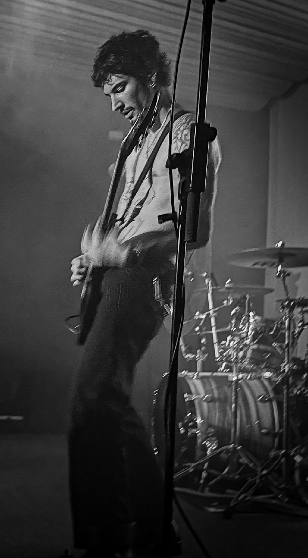 Guitarist mid-performance, monochrome